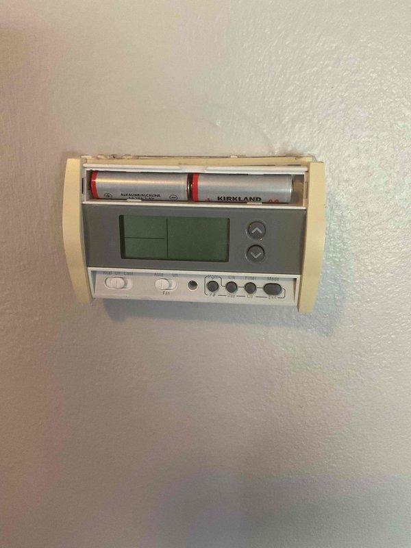 Responded to no-cooling call and diagnosed malfunctioning thermostat with damaged battery compartment preventing proper battery installation. Replaced defective thermostat with new unit, restoring system operation and customer comfort.