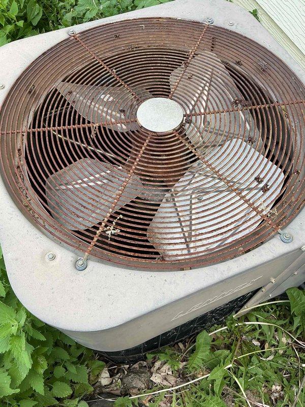 # HVAC Service Completed - No Cooling Issue Resolved

Responded to a no cooling call on a 10+ year old system. Customer reported that another contractor had previously replaced a fuse, but the unit remained non-operational. Upon arrival, performed diagnostic testing on the outdoor condensing unit and indoor air handler components.

Inspection revealed the outdoor condenser unit exhibited significant age-related deterioration, including extensive rust and corrosion on the fan grille assembly and metal components. The unit showed clear signs of prolonged outdoor exposure with weathering throughout. Vegetation had grown around the base, indicating the system had been in service for an extended period.

Diagnostic testing identified a failed compressor delay board as the root cause of the no-cooling condition. The delay board failure prevented the compressor from engaging, rendering the air conditioning system inoperable. Given the advanced age of the equipment (10+ years), the extent of v