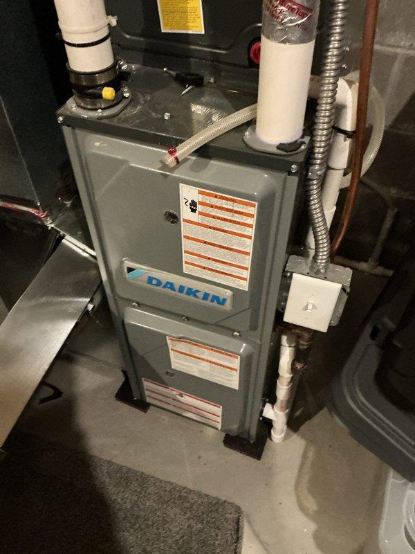 Responded to no cooling complaint on dual-zone system affecting upper level with both units inoperative. Found extensive ice formation throughout refrigerant lines extending from evaporator coil to outdoor condenser unit. Outdoor condenser coil heavily plugged with debris restricting airflow. Cleaned condenser coil thoroughly to restore proper airflow. Instructed homeowner to operate system in fan-only mode to allow complete ice thaw. Recommended retesting system operation after 24-hour thaw period and follow-up service call if cooling issues persist.