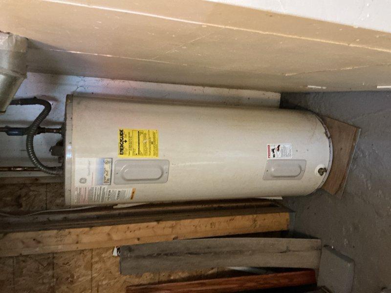 Responded to no-cool complaint on aging central air conditioning system. Upon arrival, determined unit was not operating due to thermostat programming issues. Customer had recently installed new thermostat but was unable to properly configure settings for cooling operation. Provided instruction on correct thermostat programming and operation procedures. Verified thermostat wiring connections and confirmed proper communication with outdoor condensing unit. Performed seasonal tune-up inspection of AC system, checking refrigerant levels, electrical connections, and overall system operation. System restored to normal cooling function following thermostat configuration correction.