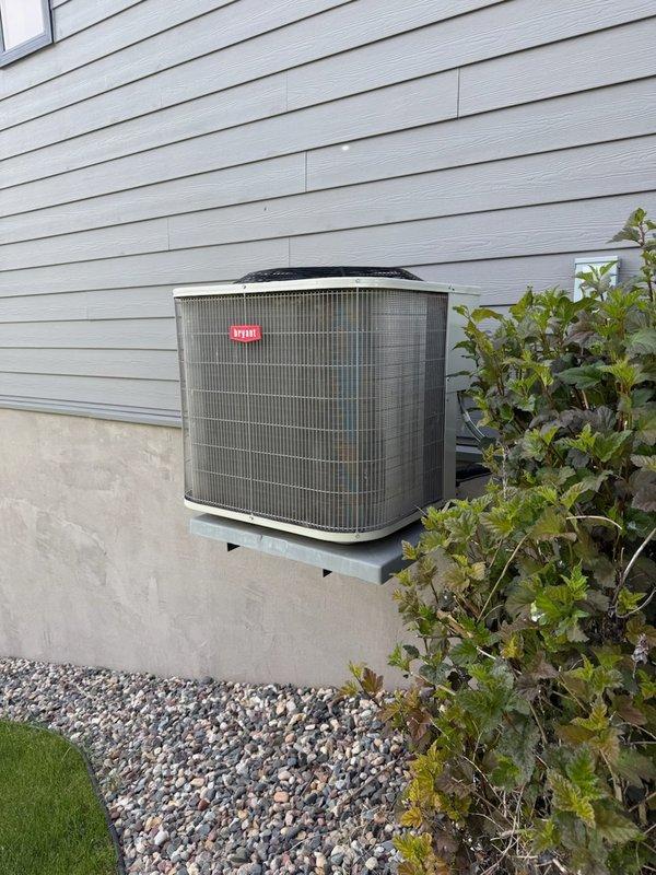 Responded to no cooling complaint on 5-year-old Bryant air conditioning system. Customer reported outdoor fan making abnormal noise indicating potential failure. Upon inspection, diagnosed failed dual run capacitor causing improper compressor and condenser fan motor operation. Removed defective capacitor and installed new dual run capacitor to manufacturer specifications. Tested system operation, confirmed proper compressor startup, verified condenser fan motor running at correct speed, and validated normal cooling cycle restoration. Unit returned to full operational status.