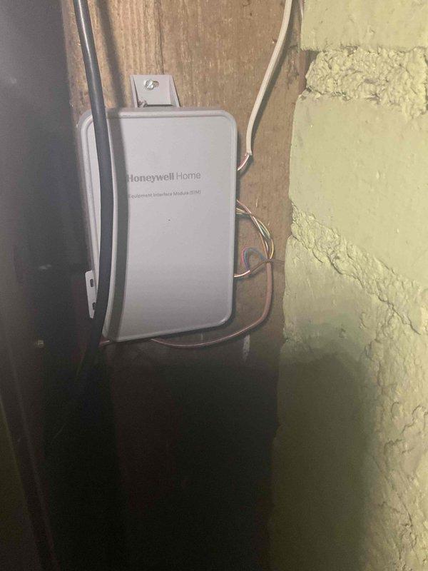 Responded to no cooling complaint on newly installed Lennox system where outdoor unit was running but indoor blower was not operating. Diagnosed faulty thermostat preventing proper system communication and blower operation. Removed defective thermostat and installed new Honeywell Home wireless thermostat with equipment interface module, completing all wiring connections per manufacturer specifications. Verified proper system operation with indoor blower running and unit cooling effectively upon completion.