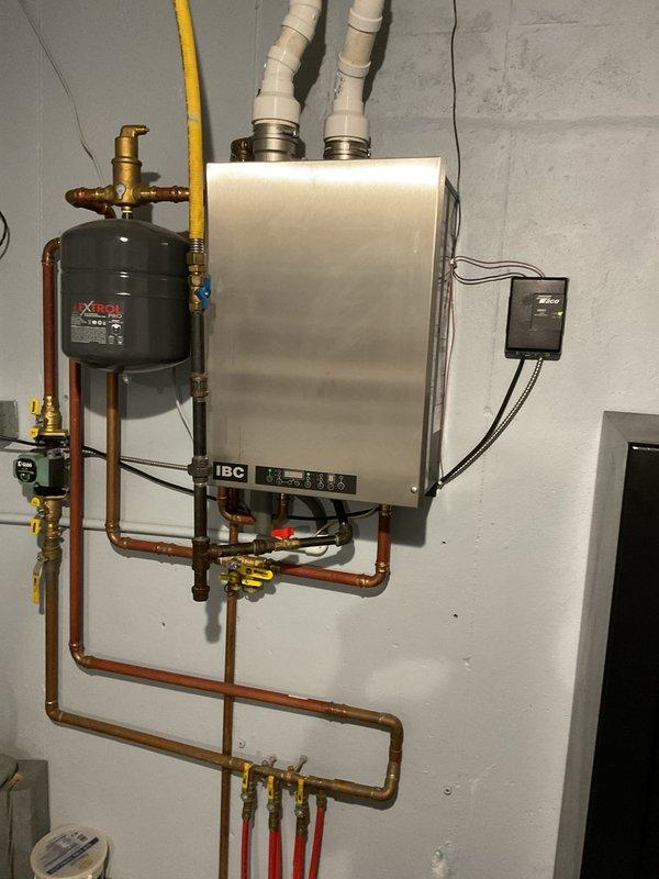 Responded to gas leak detected by LP supplier at boiler fitting in basement. Upon inspection, discovered union connection and multiple gas piping fittings were inadequately tightened from original installation approximately three years prior. Applied pipe dope and properly torqued all gas line connections including unions, valves, and fittings on the IBC boiler system. Verified all connections were secure and gas-tight. System supplies radiant floor heating to basement area, with LP supplier having shut off valve to affected line as precautionary measure prior to arrival.