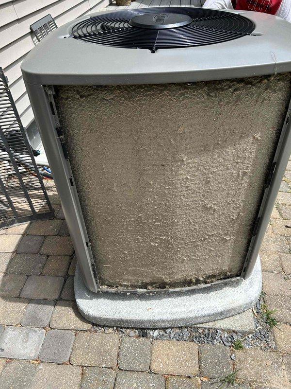 Responded to no cooling complaint on 2-year-old air conditioning system. Upon inspection, found outdoor condenser coil completely blocked with accumulated dirt, dust, and debris, causing reduced airflow and inefficient operation. Thoroughly cleaned and rinsed condenser coil, removing heavy buildup from front panel and mesh screens. After cleaning, verified system operation with proper temperature split of 20° across evaporator coil and correct subcooling readings, confirming refrigerant charge within manufacturer specifications. Unit operating quietly with restored cooling capacity. Advised homeowner on importance of regular coil maintenance to prevent future performance issues.