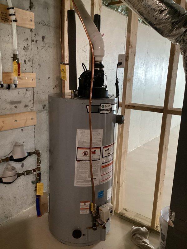Responded to water heater leak reported at top of unit with water damage extending to base. Upon inspection, identified active leaking from unions at top connections of tanked water heater. Visible rust-colored staining and corrosion present on tank surface indicated ongoing water intrusion. Removed failed union fittings and replaced with female pro unions on copper supply lines. Tested connections for proper seal and verified leak elimination. Unit restored to normal operation.