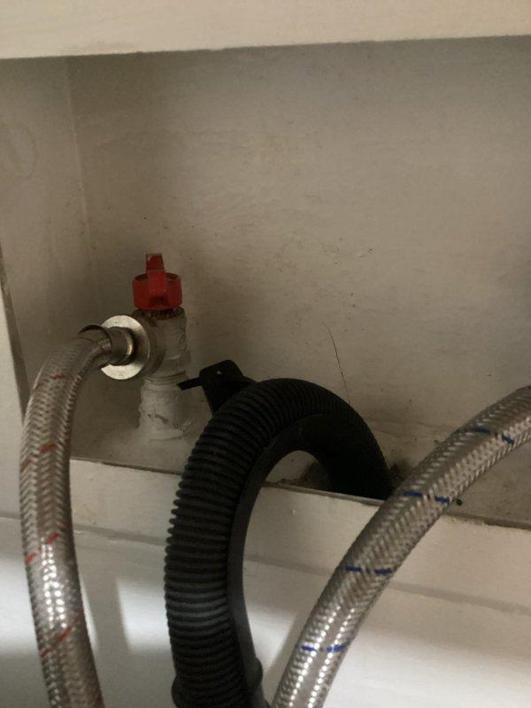 Responded to a service call for malfunctioning washing machine supply valves following washer/dryer installation. Upon inspection, found both hot and cold water shut-off valves were broken and inoperable, preventing proper water flow control to the washing machine. Successfully replaced both deteriorated valves with new quarter-turn shut-off valves featuring red handles for easy identification and operation. Installed new braided stainless steel supply lines to ensure reliable connections between the wall-mounted valves and washing machine. Tested all connections for leaks and verified proper shut-off functionality of both hot and cold water valves. System is now fully operational with secure, leak-free connections.