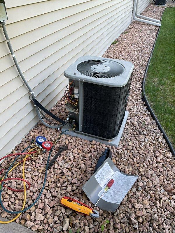 Performed comprehensive AC tune-up on 20-year-old residential cooling system as part of maintenance agreement. During routine inspection, discovered unit operating with low R22 refrigerant charge based on pressure and temperature measurements taken at outdoor condenser. Coordinated follow-up appointment with service advisor to provide replacement system estimates for both air conditioning unit and furnace due to age of equipment and refrigerant availability concerns.