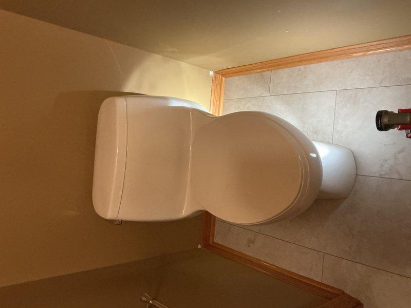 Responded to a toilet reset request following bathroom floor replacement due to previous water leak damage. Successfully reset the toilet on the newly installed tile flooring, installed a new water supply line, and performed eight flush cycles to verify proper seal and confirm no leaks were present at the base or supply connection. All fixtures tested and functioning properly upon completion.