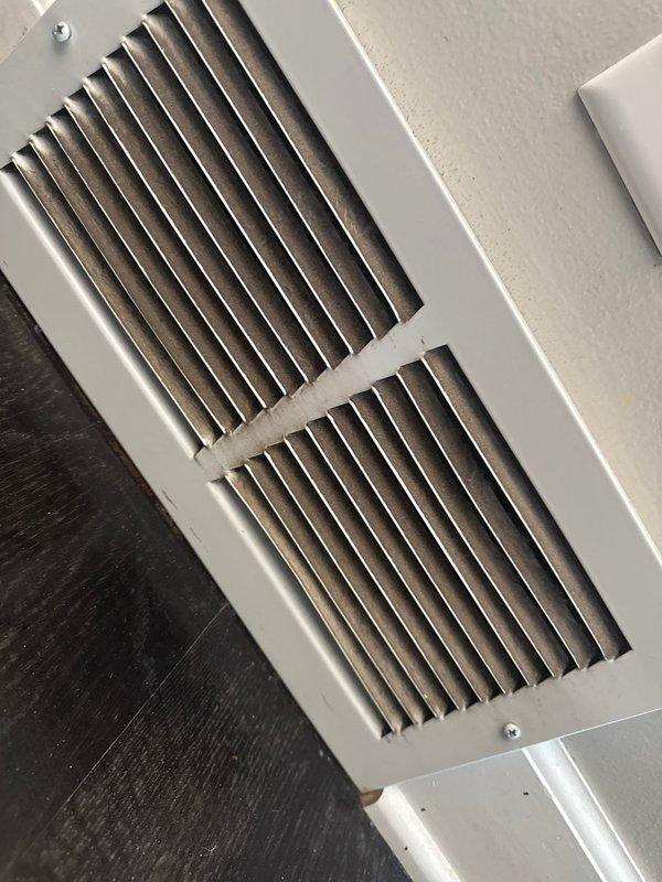 Responded to follow-up service call for AC unit struggling to maintain temperature on hot days. Verified all supply registers and temperature splits were within acceptable range with 19-degree split across coil. Return air temperature measured at 67 degrees, significantly cooler than upstairs zones, indicating potential airflow restriction or ductwork issues. Observed heavily soiled return vents with substantial dust accumulation restricting airflow and reducing system efficiency. Noted absence of supply registers in kitchen and no return vents in kitchen or living room areas, likely contributing to inadequate air circulation in remodeled home. Recommended professional duct cleaning as primary solution to address restricted airflow and improve heat removal capacity. System maintaining thermostat setpoint under current conditions but may require additional return air pathways or investigation of potential air leakage pulling return air from downstairs to fully resolve capacity concerns 