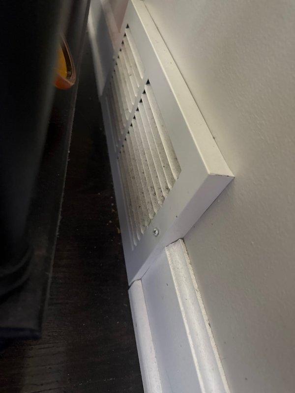 Responded to follow-up service call for AC unit struggling to maintain temperature on hot days. Verified all supply registers and temperature splits were within acceptable range with 19-degree split across coil. Return air temperature measured at 67 degrees, significantly cooler than upstairs zones, indicating potential airflow restriction or ductwork issues. Observed heavily soiled return vents with substantial dust accumulation restricting airflow and reducing system efficiency. Noted absence of supply registers in kitchen and no return vents in kitchen or living room areas, likely contributing to inadequate air circulation in remodeled home. Recommended professional duct cleaning as primary solution to address restricted airflow and improve heat removal capacity. System maintaining thermostat setpoint under current conditions but may require additional return air pathways or investigation of potential air leakage pulling return air from downstairs to fully resolve capacity concerns 