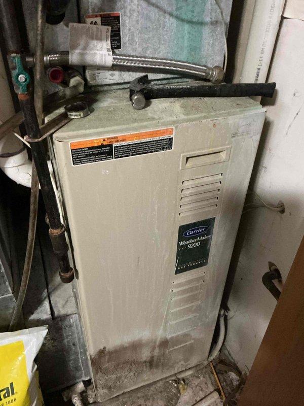 Responded to no cooling call on 25-year-old Carrier air conditioning system. Upon inspection, discovered the furnace control board had failed due to severe moisture damage and was not outputting 24V from the low voltage rail, preventing system operation. Blower motor showed signs of seizing and the associated capacitor tested out of specification. Found evidence of water accumulation around the evaporator coil, though the source and relationship to the AC issue could not be determined at this time. Condenser contactor exhibited pitting on contacts. Complete system diagnosis could not be performed without operational power to the air conditioning unit. Documented all findings with photos and discussed repair options with homeowner. Scheduled follow-up appointment with service advisor to review comprehensive repair recommendations and system replacement options given the age and condition of the equipment.
