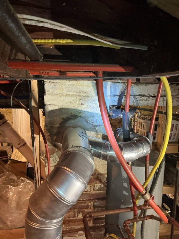 Responded to a failed inspection on a tanked water heater venting system. The original installation utilized a 4" tee fitting on the vent connection, which did not comply with Minnesota Fuel Gas Code 503.10.4.1 requirements. Removed the non-compliant tee fitting and installed a code-compliant 4" wye saddle on the water heater vent to ensure proper draft and ventilation performance per state regulations.