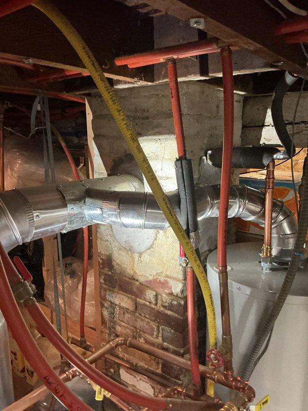 Responded to a failed inspection on a tanked water heater venting system. The original installation utilized a 4" tee fitting on the vent connection, which did not comply with Minnesota Fuel Gas Code 503.10.4.1 requirements. Removed the non-compliant tee fitting and installed a code-compliant 4" wye saddle on the water heater vent to ensure proper draft and ventilation performance per state regulations.
