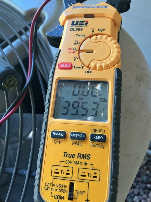 Completed annual furnace and air conditioning tune-up on 22-year-old HVAC system. Performed comprehensive inspection revealing multiple components nearing end of service life. AC unit operates with R22 refrigerant and runs louder than normal. Measured compressor amperage drawing higher than specification. Identified contactor with significant pitting and burn marks requiring replacement. Discovered blower motor with oil leakage indicating bearing wear. Control board shows evidence of thermal stress with visible hot spot. Blower wheel heavily coated with dust and debris accumulation. Documented equipment condition with multimeter readings showing 39.97 μF capacitance measurement. Discussed findings with homeowner who intends to extend system operation for additional years before replacement. Recommended monitoring contactor, blower motor, and control board as priority replacement items to prevent system failure.