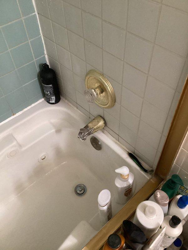 Responded to a water leak originating from a failing isolation valve located in the ceiling above the laundry room. Upon inspection, determined the valve required replacement along with the shower valve cartridge and tub spout. Successfully replaced the Moen Posi-Temp cartridge in the shower valve assembly and installed a new brushed nickel tub spout, resolving all leak issues and restoring proper function to the bathroom plumbing system.