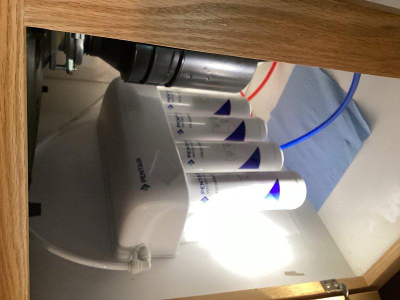 Completed routine plumbing inspection and reverse osmosis system maintenance, replacing all filter cartridges in the four-stage under-sink water filtration system. Verified proper water flow, checked all connections and tubing for leaks, and ensured the RO system was functioning correctly throughout the residence.