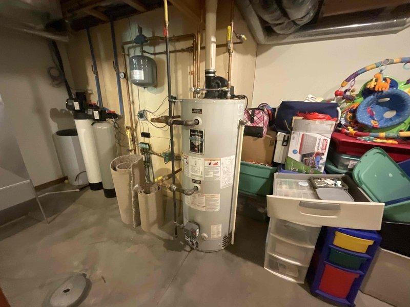 Responded to service call for assessment of water heater replacement and repair of two leaking PEX pipe connections. Conducted on-site inspection of existing water heater installation in basement utility area, documented current equipment condition and plumbing configuration with photographs. Examined two dripping PEX pipe connections requiring repair. Prepared comprehensive estimate including water heater replacement, PEX pipe leak repairs, and diagnostic work. Coordinated arrival notification with customer prior to arrival window.