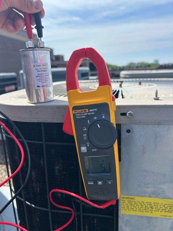 Responded to a no cooling call on an aging air conditioning system. Upon inspection of the rooftop condenser unit, diagnosed a failed run capacitor and blown fuses preventing compressor operation. Replaced the defective capacitor with a new TITAN PRO unit and installed new fuses to restore power to the condenser. Performed electrical testing using diagnostic equipment to verify proper component function and amp draw. Checked refrigerant pressures and temperatures, confirming system charge was within normal operating parameters. System restored to full cooling operation with no additional deficiencies noted. Scheduled a Comfort Advisor consultation for the customer to discuss system age and future equipment options.
