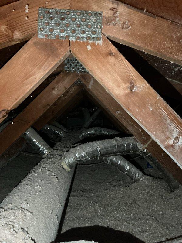 Responded to no cooling complaint on 10-year-old central air conditioning system where both condenser and air handler were reportedly not operating. Upon arrival, system powered on and ran during testing. Diagnostic evaluation revealed system is low on obsolete refrigerant and attic-mounted fan coil has severely restricted accessibility for service. Evidence suggests drain pan may have filled with condensate from frozen evaporator coil, potentially triggering safety float switch that caused initial system shutdown. Due to age of equipment, obsolete refrigerant type, and challenging service access in attic installation, scheduled same-day estimate for mini-split system replacement and removal of existing condenser unit.