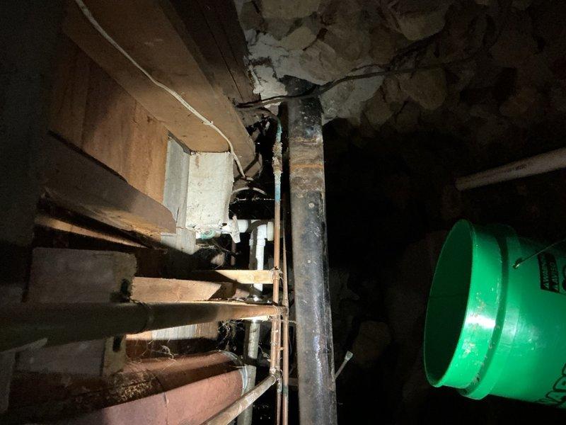 Responded to a bathtub drain that was completely non-functional due to a severely clogged custom drum trap. Upon inspection in the basement utility area, found the existing drum trap was plugged solid and beyond cleaning. Removed the obsolete drum trap assembly and replaced it with new Schedule 40 PVC trap configuration to restore proper drainage and meet current plumbing code standards.