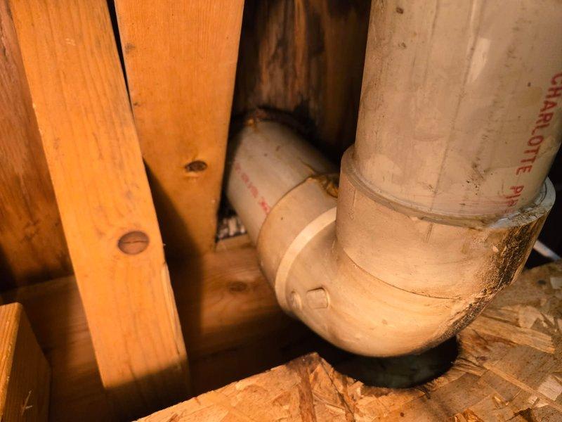 Responded to report of toilet leaking at base with water stains visible on basement ceiling below. Upon inspection, confirmed water infiltration through bathroom floor into basement area. Removed toilet from floor flange to access leak source. Found failed wax ring seal allowing water to bypass the toilet base and penetrate subflooring. Installed new wax ring seal and properly reset toilet to floor flange, ensuring watertight connection between fixture and drain system.