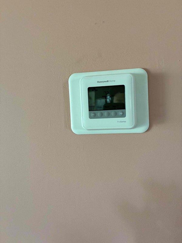 Responded to no cooling complaint where system was short cycling, running 30-45 seconds before thermostat would kick out on delay and repeat the cycle. Performed diagnostic testing on outdoor unit including low voltage verification, secured connections with new wire nuts, and ohm tested contactor coil which measured 17 ohms (within specification) and drew 0.29 amps when energized. After systematically verifying all wiring at outdoor unit, furnace, and thermostat location, determined thermostat was faulty. Replaced defective thermostat with new Honeywell Home ProSeries T4 unit, verified proper wiring connections throughout system, and monitored operation for approximately 20 minutes to confirm proper cycling with temperature降cooling to setpoint and system shutting off as designed.