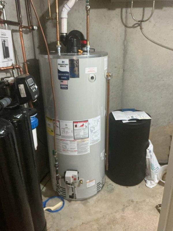Installed 75-gallon natural gas power vent water heater in basement utility area, replacing existing like unit with all necessary connections to copper supply lines and PVC venting system. Replaced standard hose bibb stem and inspected cracked pipe on irrigation system. Permit obtained as required for installation.