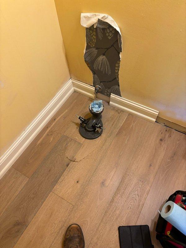 Removed toilet from bathroom to allow homeowner access for wallpaper installation. Disconnected water supply, unbolted fixture from flange, and carefully relocated toilet to laundry room for temporary storage. Fixture will be reset at a later appointment, at which time a customer-supplied lavatory faucet will also be installed.