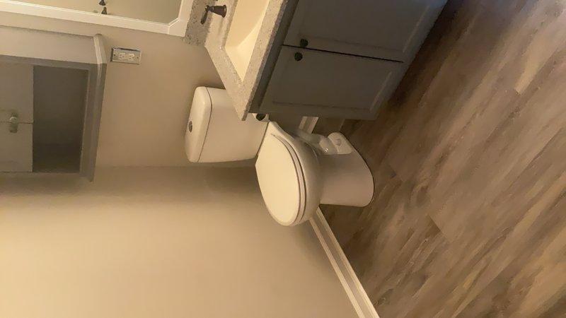 Responded to upstairs toilet leak caused by loose fixture. Upon inspection, confirmed toilet was not properly secured to floor flange, resulting in water seepage around base. Removed toilet from mounting position, inspected wax ring and flange for damage, and reinstalled toilet with proper sealing and secure mounting. Verified leak was resolved and fixture operates correctly.