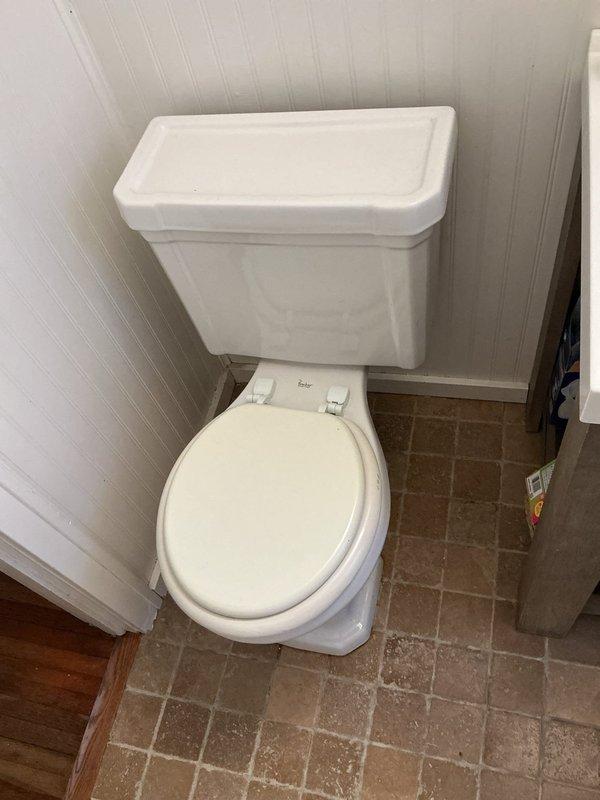 Replaced existing toilet that was experiencing slow flushing issues with a new Gerber round front toilet featuring a 14-inch rough-in configuration to ensure proper clearance from the bathroom door. Installation included new wax ring, mounting bolts, and complete fixture setup. Upon completion, tested toilet for proper flush operation and verified no leaks were present at all connection points.