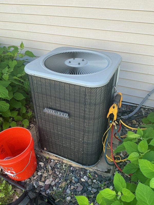 Responded to no cooling complaint on 11-year-old AIRE-FLO air conditioning system. Upon arrival, confirmed unit was not operating properly and cycling intermittently. Performed diagnostic testing with manifold gauges and determined system was low on refrigerant charge. Low refrigerant level caused low pressure safety switch to trip, preventing compressor operation and eliminating cooling capacity. Identified refrigerant type as obsolete R-22, making recharge cost-prohibitive and availability limited. Given age of equipment, declining efficiency, and obsolete refrigerant requiring expensive repairs, recommended full system replacement rather than repair. Discussed options and benefits of upgrading to modern high-efficiency unit with current R-410A refrigerant. Scheduled same-day estimate for new air conditioning system installation to restore cooling comfort.