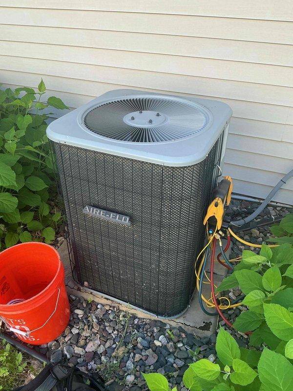 Responded to no cooling complaint on 11-year-old AIRE-FLO air conditioning system. Upon arrival, confirmed unit was not operating properly and cycling intermittently. Performed diagnostic testing with manifold gauges and determined system was low on refrigerant charge. Low refrigerant level caused low pressure safety switch to trip, preventing compressor operation and eliminating cooling capacity. Identified refrigerant type as obsolete R-22, making recharge cost-prohibitive and availability limited. Given age of equipment, declining efficiency, and obsolete refrigerant requiring expensive repairs, recommended full system replacement rather than repair. Discussed options and benefits of upgrading to modern high-efficiency unit with current R-410A refrigerant. Scheduled same-day estimate for new air conditioning system installation to restore cooling comfort.