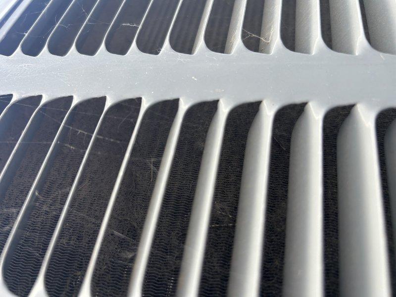 Responded to no cooling complaint on upper level of residence with 4-5 year old system. Upon arrival, inspected indoor air handler and discovered humidifier bypass damper was positioned in winter mode, restricting proper airflow. Corrected damper position to summer mode for optimal circulation. Verified air filter was clean and in acceptable condition.

Proceeded to outdoor condenser unit and found significant debris accumulation on condenser coil affecting heat transfer efficiency. Verified capacitor tested within acceptable range and all electrical connections were secure. Performed thorough condenser coil cleaning to remove dirt, dust, and debris buildup from fins and coil surfaces.

Following cleaning, conducted system performance testing including refrigerant pressure and temperature measurements. All pressures and temperatures measured within manufacturer specifications, confirming system is operating properly with adequate refrigerant charge. Adjusted thermostat fan setting from