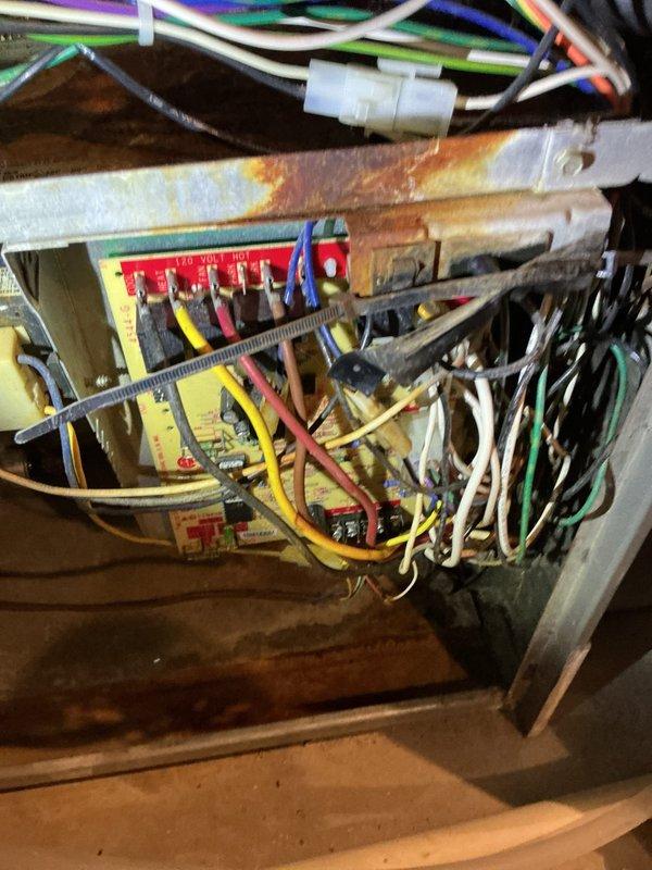 Responded to no-cool call on 22-year-old Lennox furnace system with non-operational outdoor condensing unit. Upon inspection, identified multiple critical component failures including blower motor with oil leak, draft inducer motor malfunction, and failed control board exhibiting extensive rust and corrosion damage from moisture exposure. Performed refrigerant leak search on outdoor unit, completed system recharge, and replaced defective blower motor, exhaust inducer motor, and corroded control board. Recommended comfort advisor consultation due to age of equipment and extent of deterioration observed throughout system components.