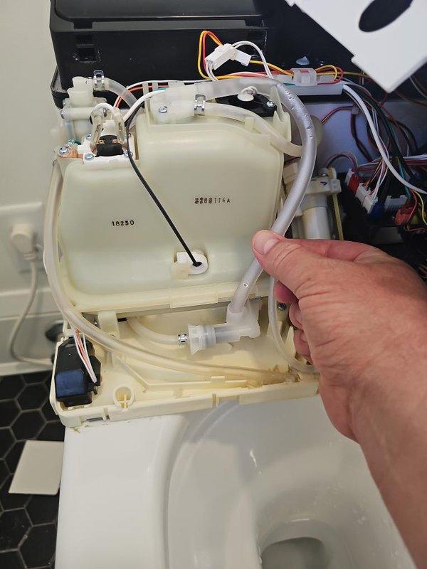 Responded to callback for toilet experiencing persistent leaking and grumbling noises following previous service. Installed manufacturer-supplied replacement parts including water shut-off valve and solenoid assembly. Performed complete function test of electronic flush system, verified all components operating correctly, and monitored overflow drain for 15 minutes to confirm leak was fully resolved. Unit left in proper working order with no water discharge detected.