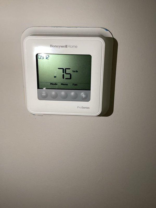 Completed routine AC maintenance tune-up on system. Performed standard diagnostics including electrical measurements with multimeter and verified thermostat operation showing 76°F with fan running. No issues found during inspection.