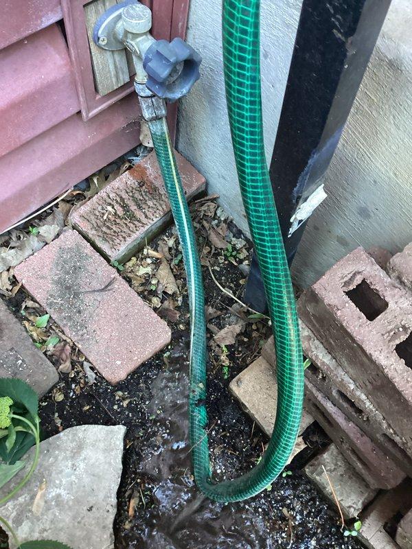 Responded to service call for leaking outdoor hose bib connection. Upon arrival, found compromised garden hose attached to exterior spigot with visible water leakage at connection point, likely resulting from previous amateur repair attempts. Removed damaged hose, inspected hose bib fixture for proper operation and seal integrity, and installed new reinforced garden hose with proper threaded connection to exterior spigot. Tested system under full water pressure to verify leak-free operation and proper flow rate.
