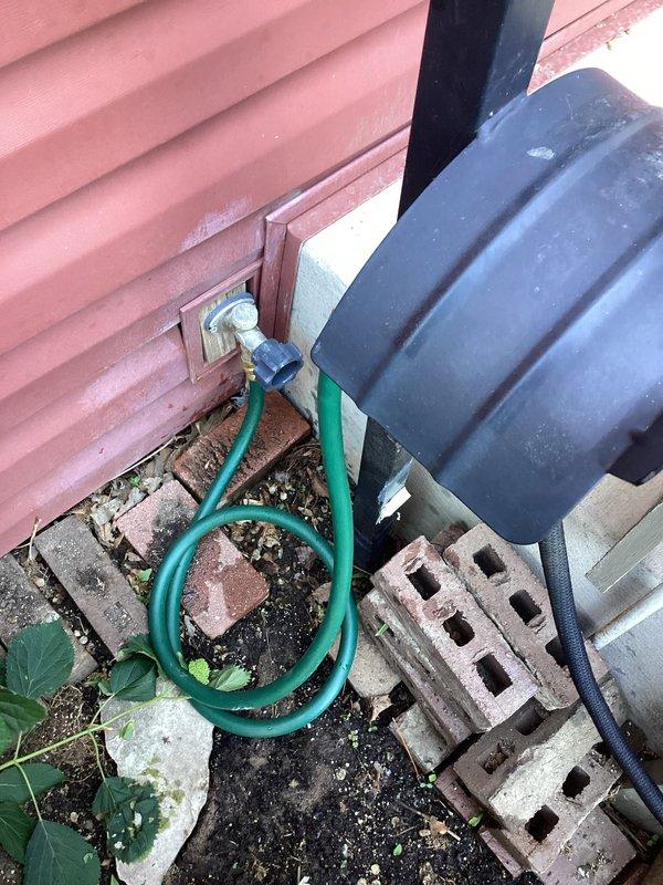 Responded to service call for leaking outdoor hose bib connection. Upon arrival, found compromised garden hose attached to exterior spigot with visible water leakage at connection point, likely resulting from previous amateur repair attempts. Removed damaged hose, inspected hose bib fixture for proper operation and seal integrity, and installed new reinforced garden hose with proper threaded connection to exterior spigot. Tested system under full water pressure to verify leak-free operation and proper flow rate.