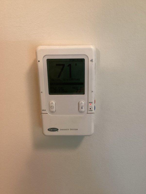 Responded to no cooling complaint on 19-year-old Carrier Infinity heat pump system. Verified thermostat wiring and voltage at control board, confirmed proper connections at terminal blocks. Diagnosed communication failure between indoor unit and outdoor condenser—system unable to send signal to outdoor unit for cooling operation. Inspected heat exchanger during troubleshooting process. Due to age of equipment and communication board failure, provided part pricing information and scheduled system replacement estimate.