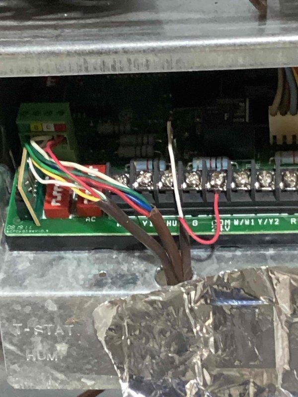 Responded to no cooling complaint on 19-year-old Carrier Infinity heat pump system. Verified thermostat wiring and voltage at control board, confirmed proper connections at terminal blocks. Diagnosed communication failure between indoor unit and outdoor condenser—system unable to send signal to outdoor unit for cooling operation. Inspected heat exchanger during troubleshooting process. Due to age of equipment and communication board failure, provided part pricing information and scheduled system replacement estimate.