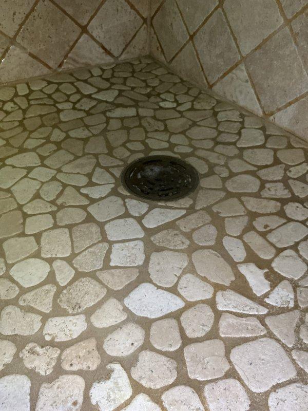 Responded to service call for shower drain backup in bathroom with pebble-stone tile flooring. Upon inspection, diagnosed clog as likely caused by accumulated hair buildup restricting water flow through the drain line.

Performed mechanical cabling of the shower drain to clear the obstruction. Successfully extracted a large hair ball that was blocking the drain pipe. Following removal of the blockage, tested the drain system by running water for approximately 10 minutes to verify proper drainage and flow rate. Confirmed no backup occurred and drain was operating at full capacity.

As part of semi-annual maintenance service, performed flush and inspection of the residential water heater located in the utility room. Drained sediment from tank bottom to improve heating efficiency and extend equipment lifespan. Conducted visual inspection of water heater components including temperature and pressure relief valve, supply lines, and connections. Verified proper operation of all water heater 