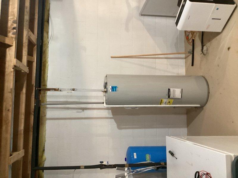Responded to no hot water complaint on 10-12 year old electric water heater. Diagnosed failed lower heating element causing complete loss of hot water production. Due to age of unit and extent of failure, recommended and completed full water heater replacement. Removed existing electric water heater and installed new unit with proper electrical connections to existing panel. Verified all copper supply line connections, tested unit operation, and confirmed hot water delivery restored to residence.