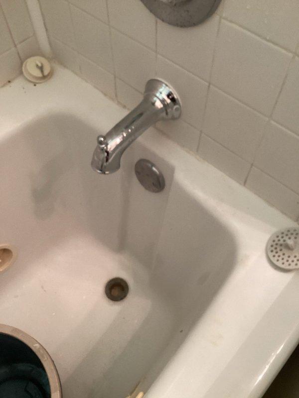 Responded to service call for shower cartridge inspection and toilet evaluation. Upon assessment, identified leaking tub spout with water discharge from the backside connection point. Determined existing tub spout was defective and required replacement. Successfully removed old tub spout and installed new unit, ensuring proper seal and connection to eliminate leak. Verified installation with pressure test to confirm no further water seepage from backside of fixture.