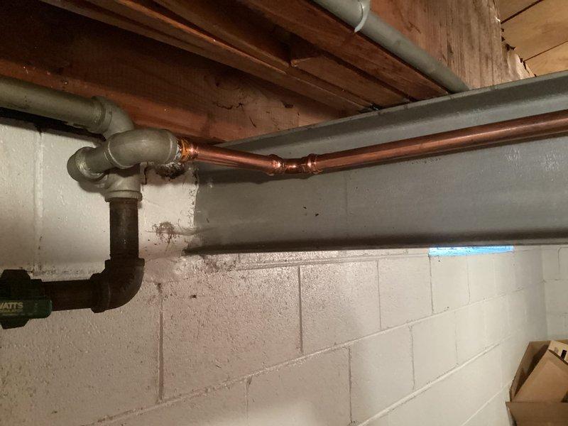 Responded to gas leak in basement identified by utility company. Found active leak at 3/4-inch tee fitting on low-pressure gas line. Gas supply to home was shut off for safety. Replaced faulty tee fitting and approximately 10 feet of 3/4-inch gas line to eliminate leak. Tested system for proper operation and verified no additional leaks present before restoring gas service.