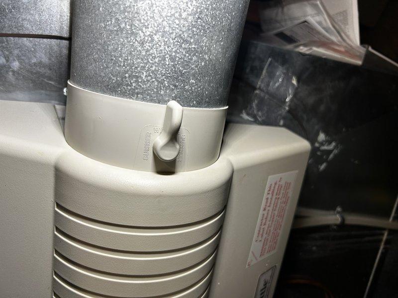 Responded to no cooling complaint and found evaporator coil completely iced up with water pooling beneath furnace. Outdoor unit was not operating due to compressor overheating from low suction pressure caused by ice buildup. Allowed compressor to cool and verified unit would fire, then shut system down to permit ice to melt completely. Diagnosed multiple contributing factors to freeze-up condition: dirty air filter requiring replacement, humidifier damper incorrectly positioned in winter mode allowing cold air dump into return plenum (repositioned to summer mode), and faulty RDS board failing to send proper power to thermostat causing intermittent blank screen and erratic fan operation while outdoor unit ran at full capacity. Temporarily bypassed RDS board to restore functionality. Returned on second visit with replacement RDS board and found system running properly with ice melted. Installed new RDS board, configured dip switches to activate sensor one, and verified proper system oper