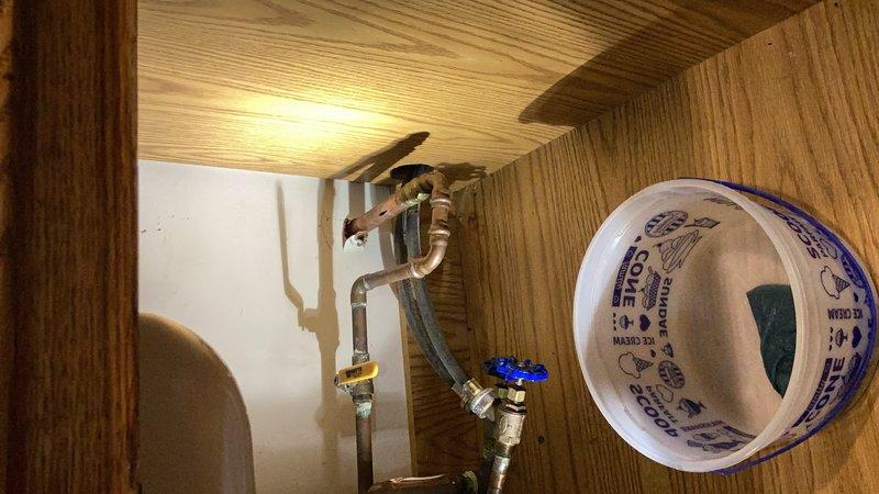 Responded to emergency call for frozen outdoor hose bibb that leaked into laundry room. The existing hose bibb had previously been identified as needing replacement and had now failed, causing water intrusion inside the home. Shut off water supply to the affected fixture to prevent further flooding. Removed damaged frozen hose bibb and installed new frost-proof hose bibb with proper valve assembly. Tested new installation for leaks and verified proper operation of shut-off valve with blue handle. Confirmed no additional water intrusion and restored exterior water access.