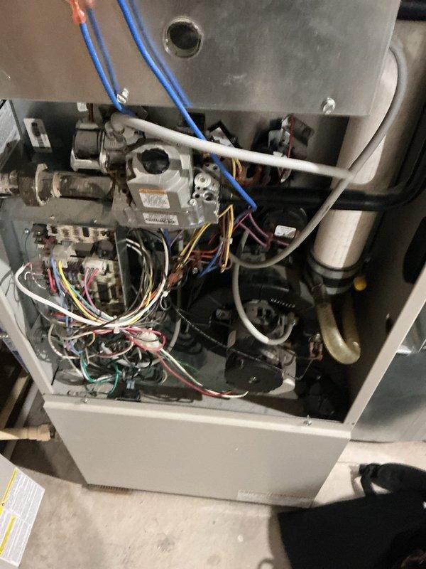 Completed comprehensive AC maintenance tune-up on 20-year-old R22 system with condenser coil located in basement. Removed significant cottonwood debris accumulation from condenser coil and inspected all system components including gas valve connections, control board, blower assembly, and electrical wiring harnesses. Replaced 16x20x1 ultimate allergen reduction air filter, verified system operation, and confirmed unit is currently functioning properly despite age; noted system uses R22 refrigerant and recommended monitoring due to advanced age of equipment.