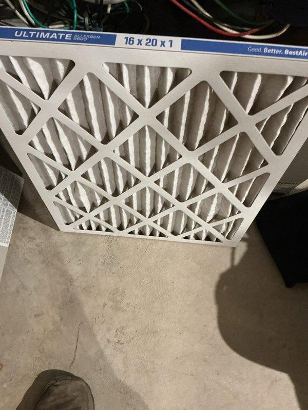 Completed comprehensive AC maintenance tune-up on 20-year-old R22 system with condenser coil located in basement. Removed significant cottonwood debris accumulation from condenser coil and inspected all system components including gas valve connections, control board, blower assembly, and electrical wiring harnesses. Replaced 16x20x1 ultimate allergen reduction air filter, verified system operation, and confirmed unit is currently functioning properly despite age; noted system uses R22 refrigerant and recommended monitoring due to advanced age of equipment.