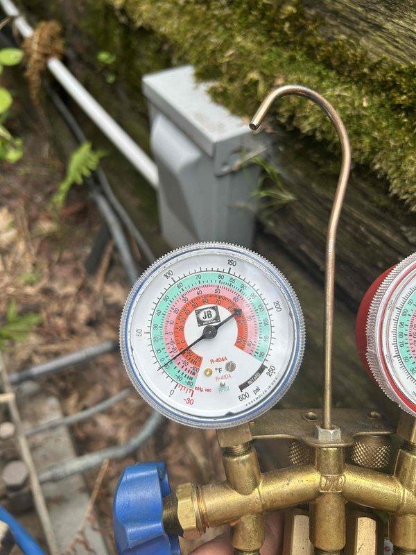 Responded to no cooling complaint on 1996 Rheem air conditioning system. Upon arrival, homeowner reported unit had been icing up repeatedly despite cleaning both condenser and evaporator coils. Connected manifold gauges to system and measured suction pressure at approximately 5 psi, indicating severe refrigerant loss. System is operating on R-22 refrigerant and essentially flat. Discussed refrigerant options, EPA regulations, and certification requirements with homeowner. Recommended system replacement due to age of equipment and refrigerant phase-out. Homeowner declined immediate replacement and will discuss options with family.