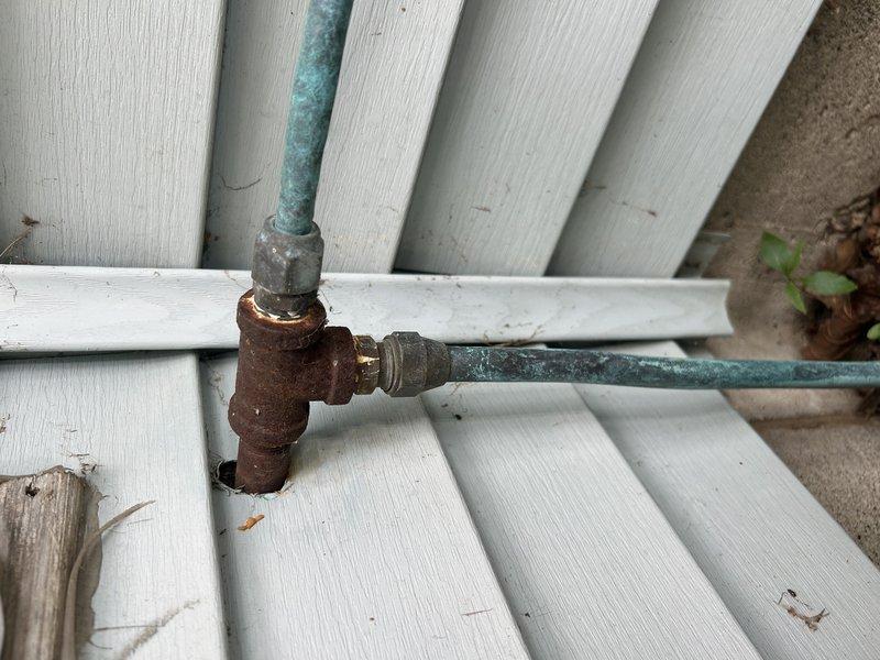 Responded to utility company requirement to cap disconnected gas line serving old pool heater. Located main gas supply entry point and shut off gas to home. Identified pool heater gas line exit point at exterior wall before line runs underground. Successfully capped gas line at exterior wall location, allowing for future removal of underground portion during landscaping work. Performed leak check on capped line and verified system integrity. All work completed to code with no leaks detected.